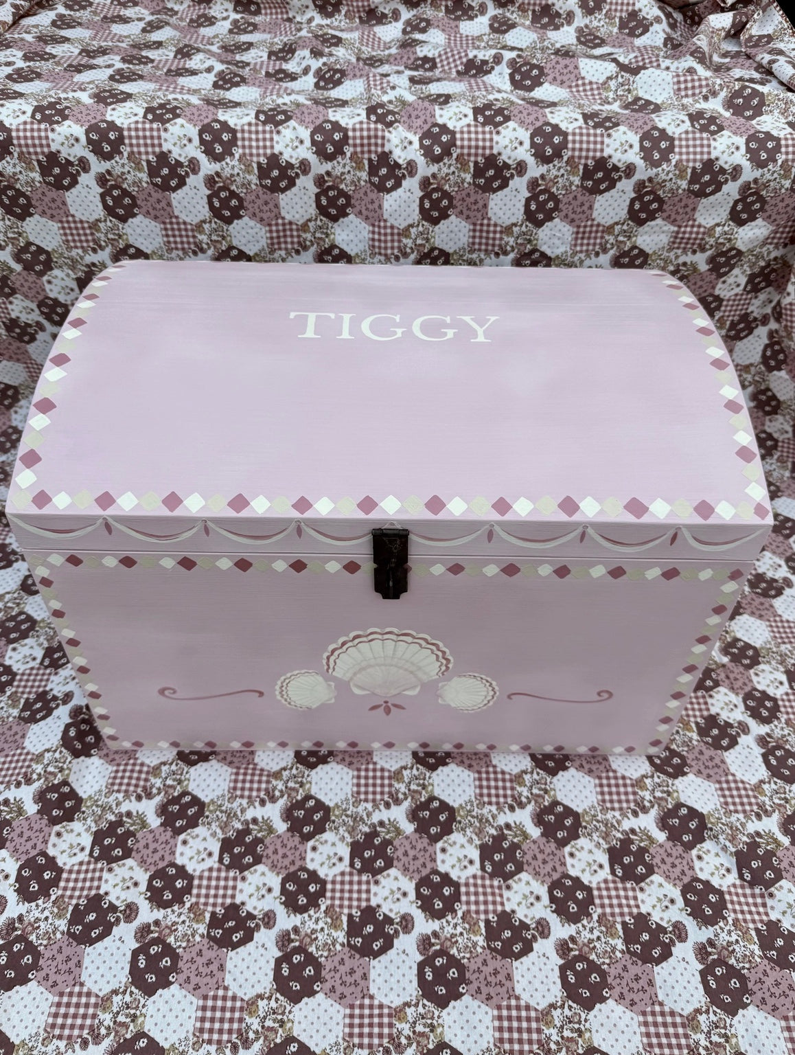 Pink hand-painted personalised wooden toy chest with scallop shell illustrations and Tiggy lettering